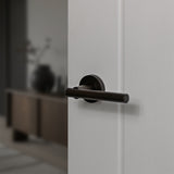 Quality image of STATUS Nebraska Lever Door Handle on Round Rose - Urban Dark Bronze | Sku. s28rudb | available from Trade Door Handles.