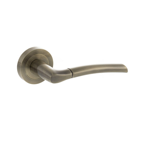 Quality image of STATUS Indiana Lever Door Handle on Round Rose - Antique Brass | Sku. s33rab | available from Trade Door Handles.