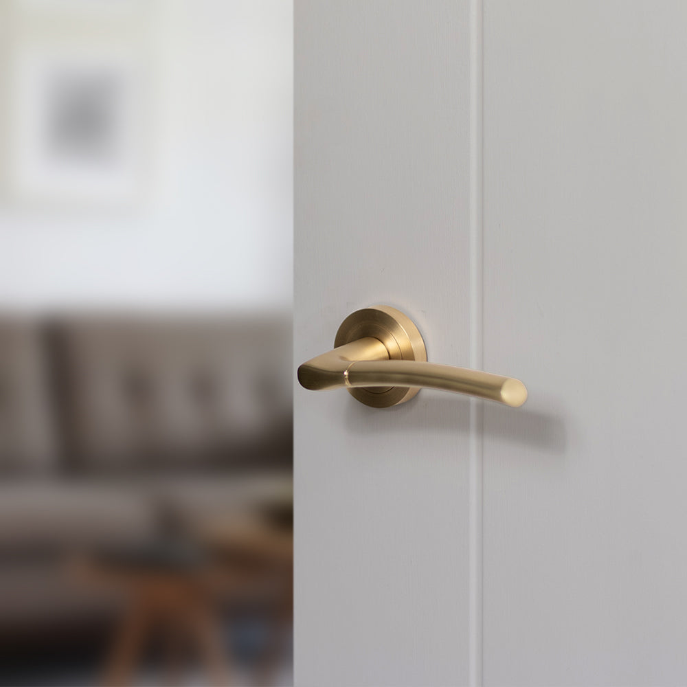 Quality image of STATUS Indiana Lever Door Handle on Round Rose - Satin Brass | Sku. s33rsb | available from Trade Door Handles.