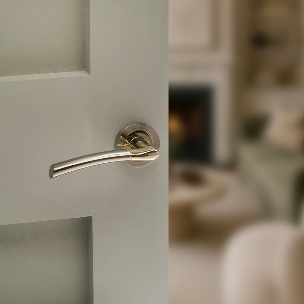 Quality image of STATUS Indiana Lever Door Handle on Round Rose - Satin Nickel/Polished Brass | Sku. s33rsnbp | available from Trade Door Handles.