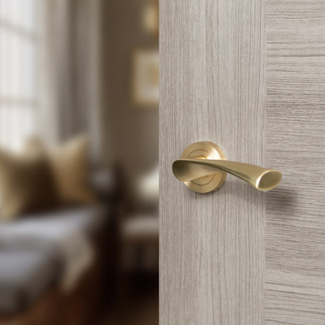 Quality image of STATUS Colorado Lever Door Handle on Round Rose - Satin Brass | Sku. s34rsb | available from Trade Door Handles.