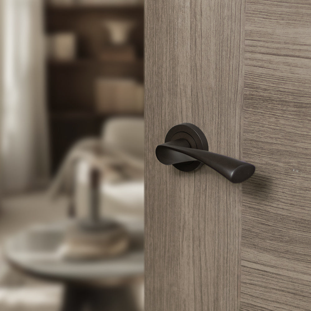 Quality image of STATUS Colorado Lever Door Handle on Round Rose - Urban Dark Bronze | Sku. s34rudb | available from Trade Door Handles.