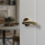 Quality image of STATUS Texas Lever Door Handle on Round Rose - Satin Brass | Sku. s35rsb | available from Trade Door Handles.