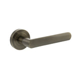 Quality image of STATUS Carolina Lever Door Handle on Round Rose - Antique Brass | Sku. s42rab | available from Trade Door Handles.