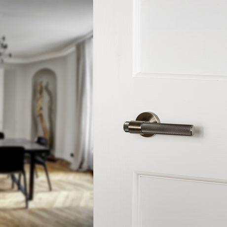 Quality image of Senza Pari Andretta Knurled Lever Door Handle on Minimal Round Rose - Antique Brass | Sku. spr160ab | available from Trade Door Handles.