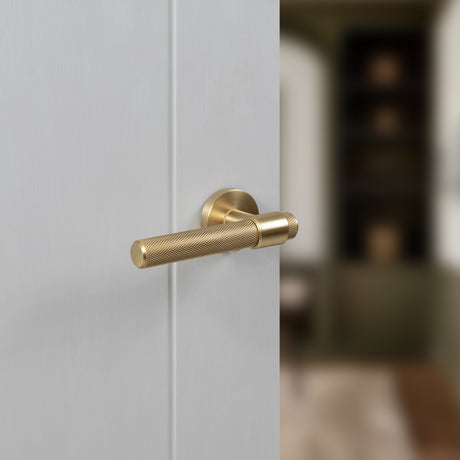 Quality image of Senza Pari Andretta Knurled Lever Door Handle on Minimal Round Rose - Satin Brass | Sku. spr160sb | available from Trade Door Handles.