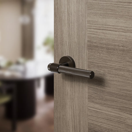 Quality image of Senza Pari Andretta Knurled Lever Door Handle on Minimal Round Rose - Urban Dark Bronze | Sku. spr160udb | available from Trade Door Handles.