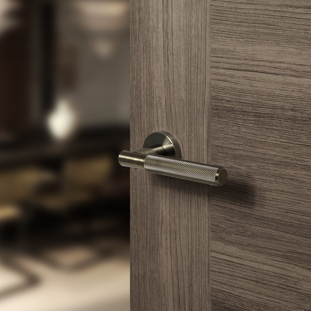 Quality image of Senza Pari Rosarno Knurled Lever Door Handle on Minimal Round Rose - Antique Brass | Sku. spr170ab | available from Trade Door Handles.