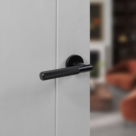 Quality image of Senza Pari Rosarno Knurled Lever Door Handle on Minimal Round Rose - Matt Black | Sku. spr170mb | available from Trade Door Handles.