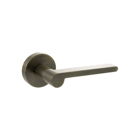 Quality image of Senza Pari Darrio Lever Door Handle on Round Rose - Antique Brass | Sku. spro218ab | available from Trade Door Handles.
