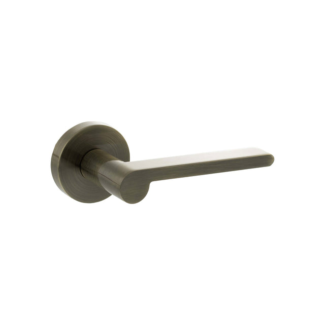 Quality image of Senza Pari Darrio Lever Door Handle on Round Rose - Antique Brass | Sku. spro218ab | available from Trade Door Handles.