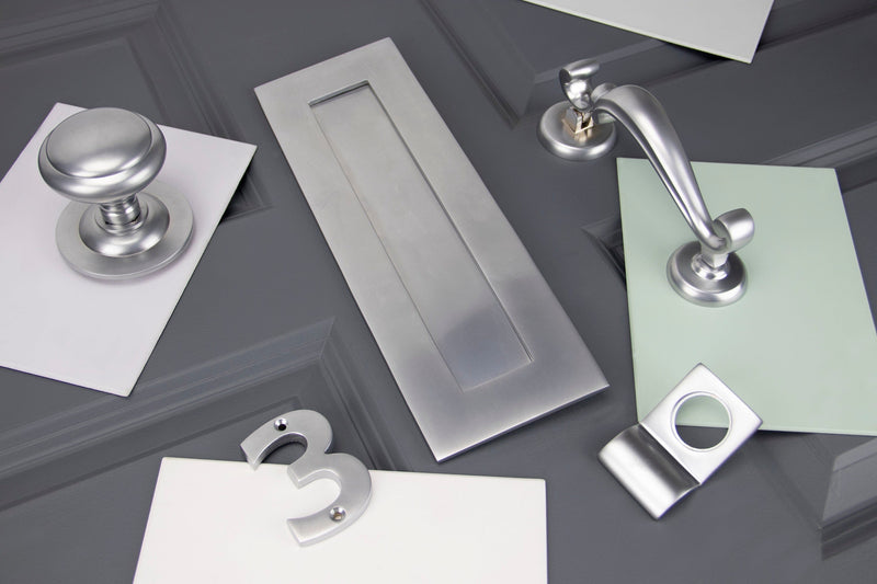 Image showing a range of From The Anvil External door furniture in Satin Chrome.  Available to order from Trade Door Handles in Kendal