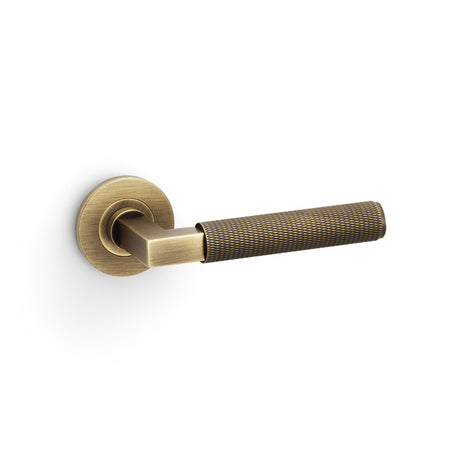 High quality image of Alexander & Wilks - Hurricane Knurled Lever on Round Rose - Antique Brass | Sku. aw200ab | Trade Door Handles.