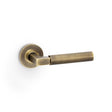 High quality image of Alexander & Wilks - Hurricane Plain Lever on Round Rose - Antique Brass | Sku. aw201ab | Trade Door Handles.