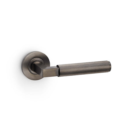 High quality image of Alexander & Wilks - Hurricane Reeded Lever on Round Rose - Dark Bronze PVD | Sku. aw202dbzpvd | Trade Door Handles.