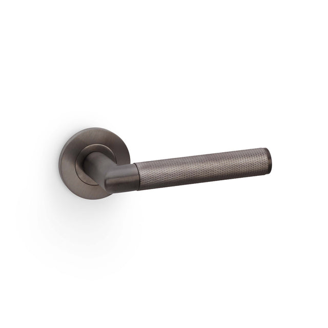 High quality image of Alexander & Wilks - Harrier Knurled Lever on Round Rose - Dark Bronze PVD | Sku. aw210dbzpvd | Trade Door Handles.
