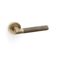 High quality image of Alexander & Wilks - Spitfire Knurled Lever on Round Rose - Antique Brass | Sku. aw220ab | Trade Door Handles.