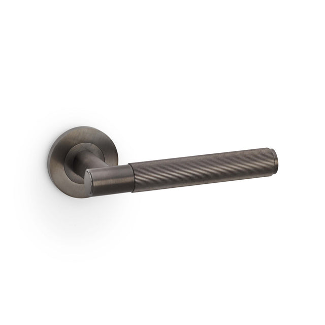 High quality image of Alexander & Wilks - Spitfire Reeded Lever on Round Rose - Dark Bronze PVD | Sku. aw222dbzpvd | Trade Door Handles.