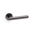 High quality image of Alexander & Wilks - Spitfire Hammered Lever on Round Rose - Dark Bronze | Sku. aw223dbz | Trade Door Handles.