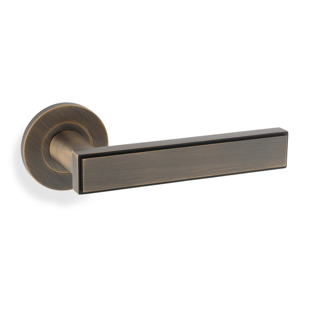 High quality image of Alexander & Wilks Jesper Lever on Rose - Antique Brass | Sku. AW260AB | Trade Door Handles.