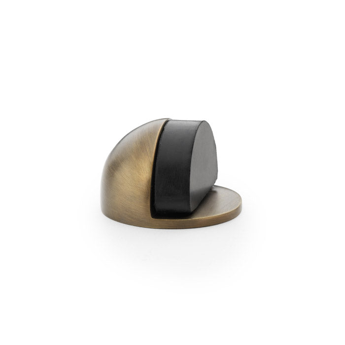 High quality image of Alexander & Wilks - Shield Floor Mounted Door Stop - Antique Brass | Sku. aw631ab | Trade Door Handles.
