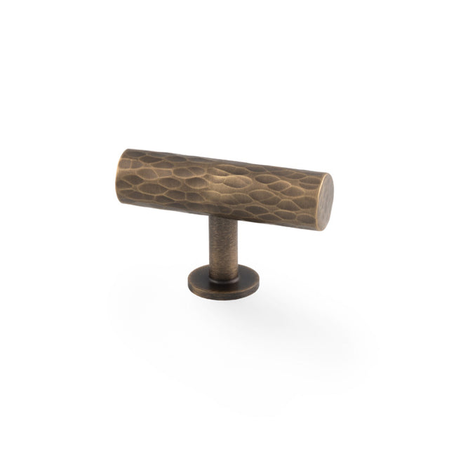 High quality image of Alexander & Wilks - Leila Hammered T-Bar Knob - Antique Brass | Sku.AW804-55-AB | Trade Door Handles.