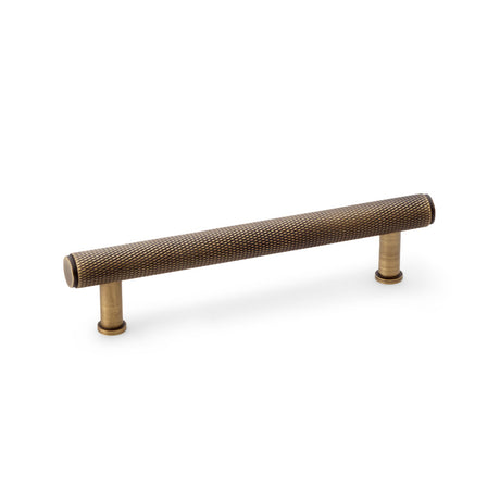 High quality image of Alexander & Wilks Crispin Knurled T-bar Cupboard Pull Handle - Antique Brass - Centres 128mm | Sku. aw809-128-ab | Trade Door Handles.