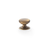 High quality image of Alexander & Wilks Waltz Round Cupboard Knob on Stepped Rose - Antique Brass - 25mm | Sku. aw825-25-ab | Trade Door Handles.