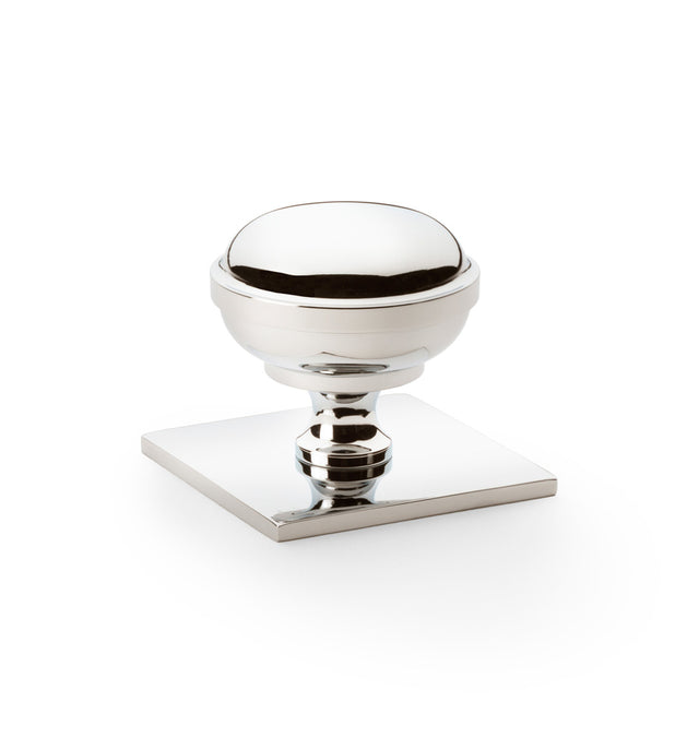 This is an image of Alexander & Wilks - Quantock Cupboard Knob on Square Backplate - Polished Nickel - 38mm available to order from Trade Door Handles in Kendal, quick delivery and discounted prices.