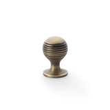 High quality image of Alexander & Wilks Caesar Cupboard Knob on Round Rose - Antique Brass - 25mm | Sku. aw832-25-ab | Trade Door Handles.