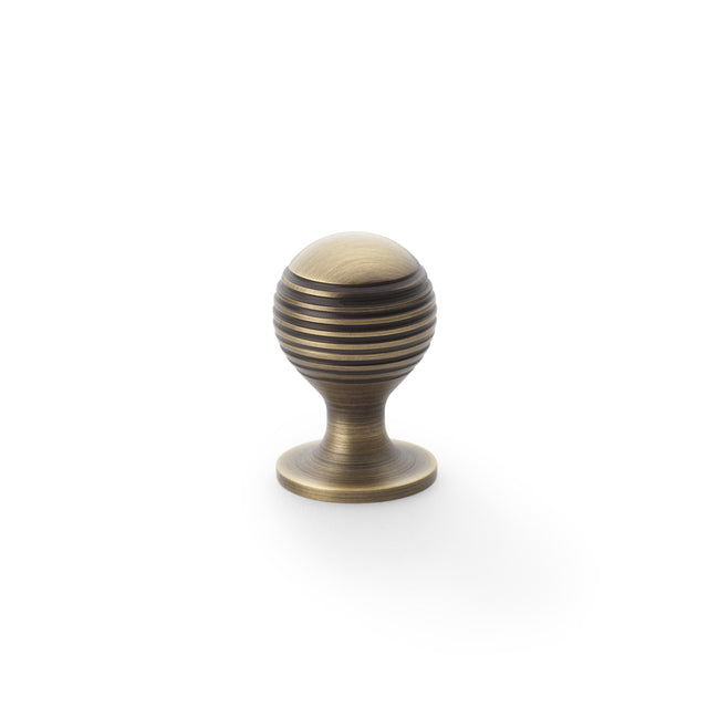 High quality image of Alexander & Wilks Caesar Cupboard Knob on Round Rose - Antique Brass - 25mm | Sku. aw832-25-ab | Trade Door Handles.