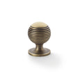 High quality image of Alexander & Wilks Caesar Cupboard Knob on Round Rose - Antique Brass - 32mm | Sku. aw832-32-ab | Trade Door Handles.
