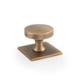 This is an image of Alexander & Wilks - Bullion Cupboard Knob on Square Backplate-Antique Brass available to order from Trade Door Handles in Kendal, quick delivery and discounted prices.