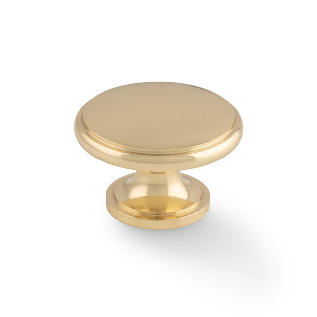 This is an image of Alexander & Wilks - Cambridge Round Cupboard Knob - Polished Brass available to order from Trade Door Handles in Kendal, quick delivery and discounted prices.