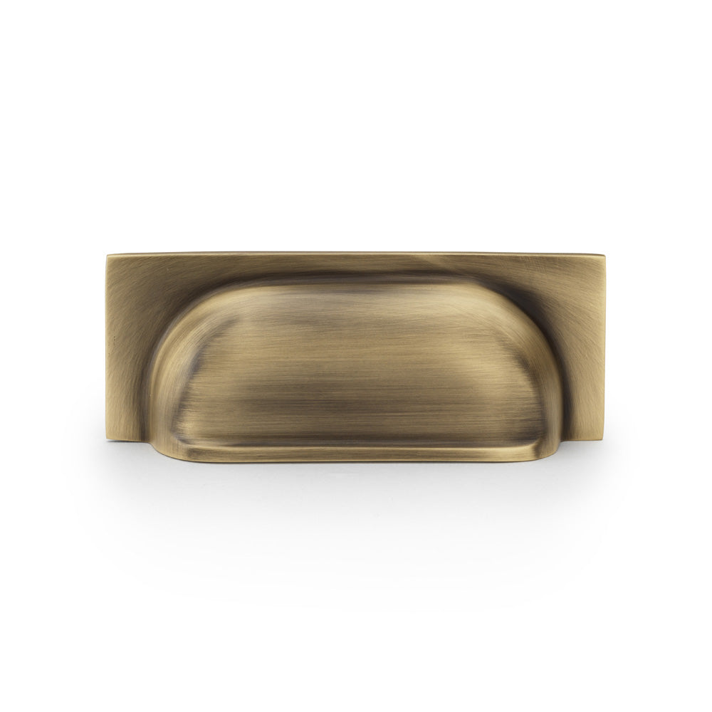 High quality image of Alexander & Wilks Quantock Cup Pull Handle - Antique Brass - Centres 96mm | Sku. aw905ab | Trade Door Handles.