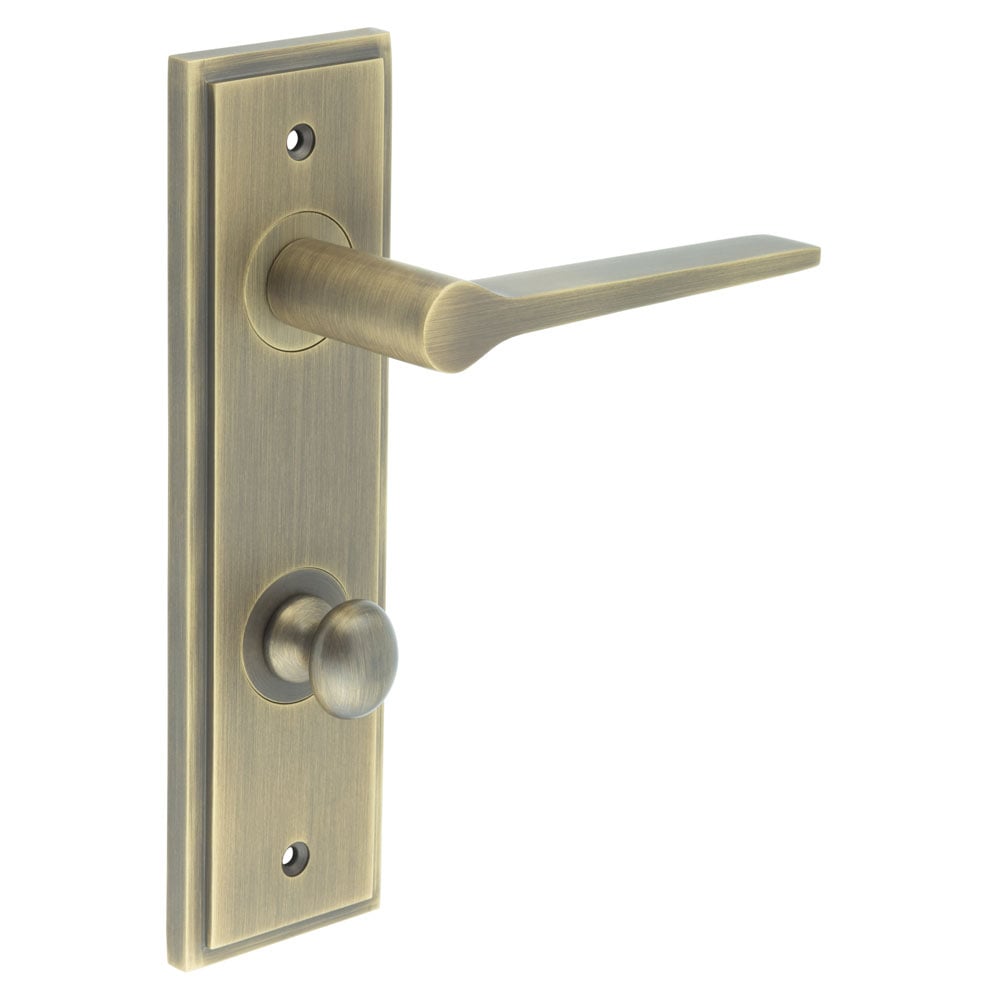 This is an image showing the Frelan - Knightsbridge Door Handle Din Bathroom Backplate Antique Brass & Turn & Release available to order from Trade Door Handles in Kendal