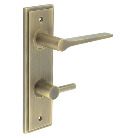 This is an image showing the Frelan - Knightsbridge Door Handle Din Bathroom Backplate Antique Brass & Turn & Release available to order from Trade Door Handles in Kendal