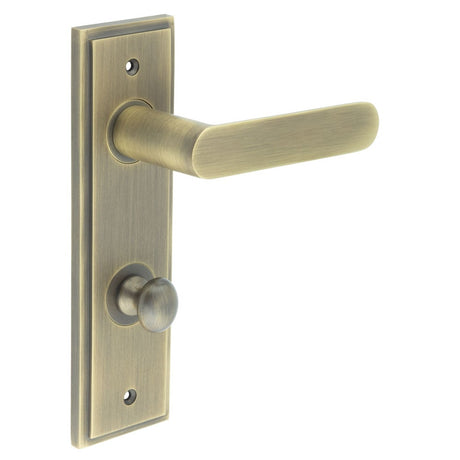 This is an image showing the Frelan - Kensington Door Handle Din Bathroom Backplate Antique Brass & Turn & Release available to order from Trade Door Handles in Kendal