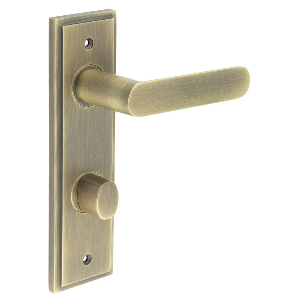 This is an image showing the Frelan - Kensington Door Handle Din Bathroom Backplate Antique Brass & Turn & Release available to order from Trade Door Handles in Kendal