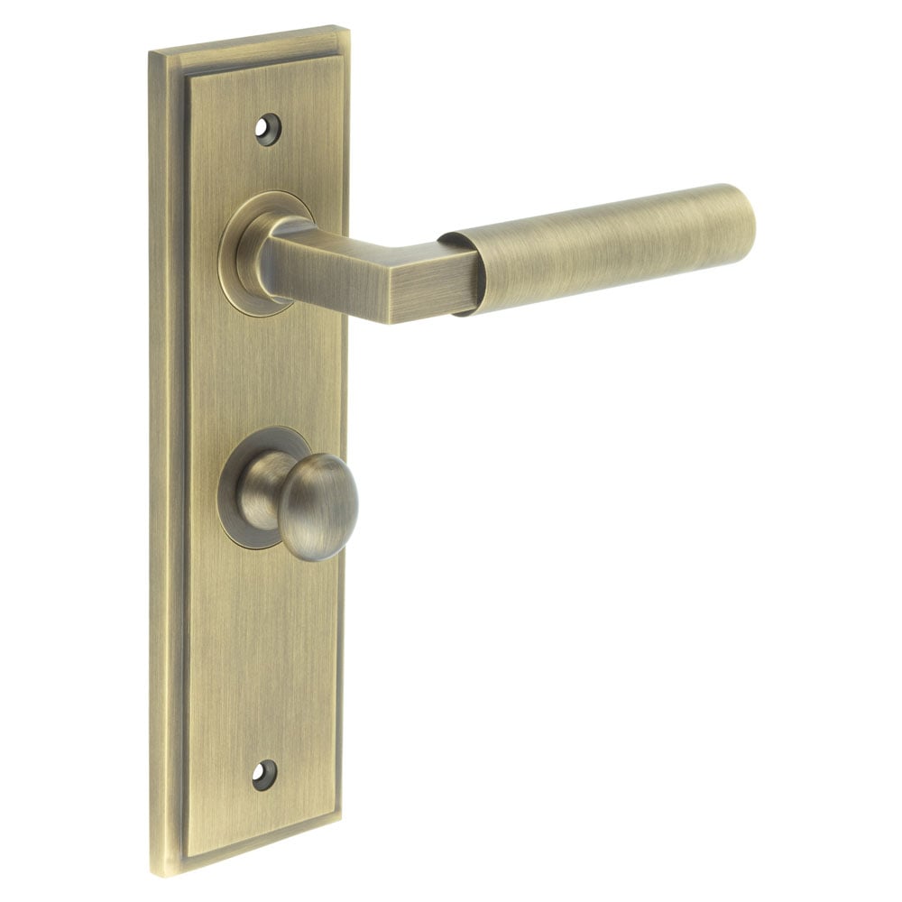 This is an image showing the Frelan - Westminster Door Handle Bathroom Backplate Antique Brass & Turn & Release available to order from Trade Door Handles in Kendal