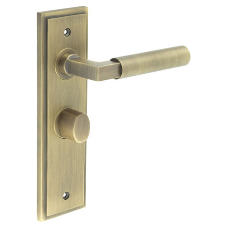 This is an image showing the Frelan - Westminster Door Handle Bathroom Backplate Antique Brass & Turn & Release available to order from Trade Door Handles in Kendal