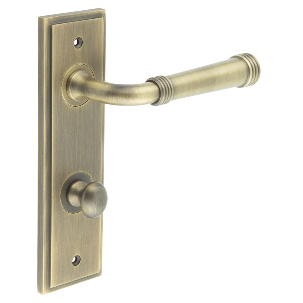 This is an image showing the Frelan - Highgate Door Handle Din Bathroom Backplate Antique Brass & Turn & Release available to order from Trade Door Handles in Kendal