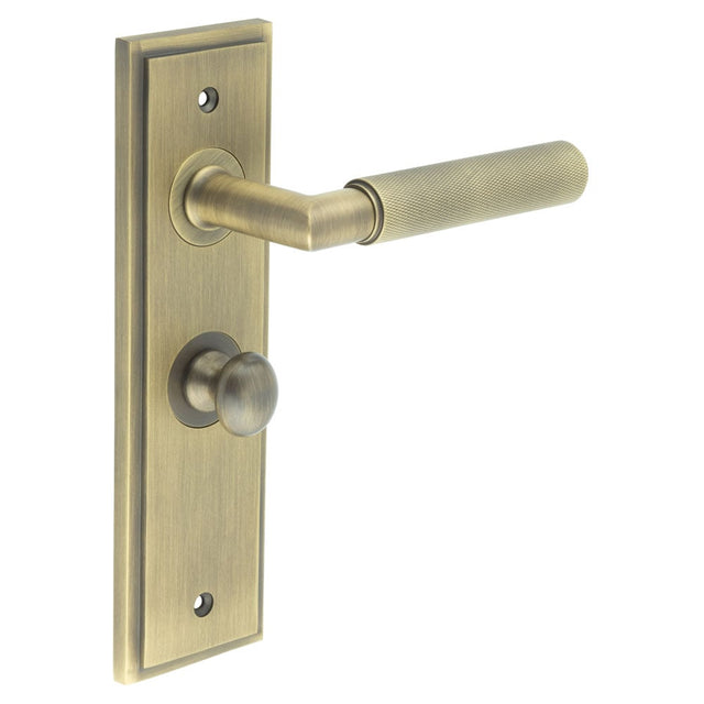 This is an image showing the Frelan - Piccadilly Door Handle Bathroom Backplate Antique Brass & Turn & Release available to order from Trade Door Handles in Kendal