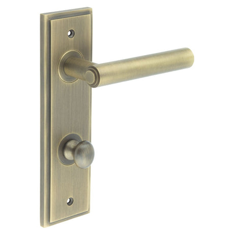 This is an image showing the Frelan - Richmond Door Handle Din Bathroom Backplate Antique Brass & Turn & Release available to order from Trade Door Handles in Kendal