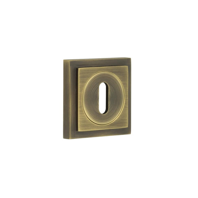 This is an image showing the Frelan - Burlington Standard Keyway Escutcheons Square Stepped Rose Antique Brass available to order from Trade Door Handles in Kendal