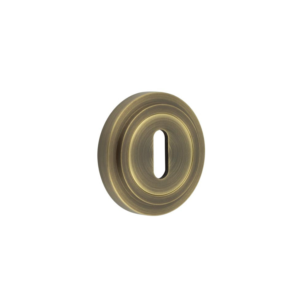 High quality image of Burlington - Standard Keyway Escutcheons Stepped Rose Antique Brass Sku. BUR-60AB-73AB