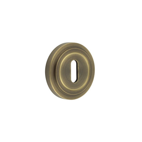 High quality image of Burlington - Standard Keyway Escutcheons Stepped Rose Antique Brass Sku. BUR-60AB-73AB