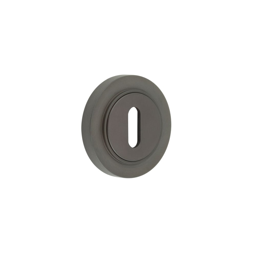 This is an image showing the Frelan - Burlington Standard Keyway Escutcheons Plain Rose Dark Bronze available to order from Trade Door Handles in Kendal