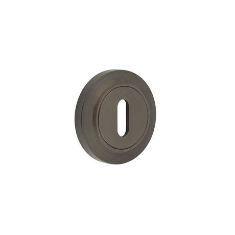 This is an image showing the Frelan - Burlington Standard Keyway Escutcheons Chamfered Rose Dark Bronze available to order from Trade Door Handles in Kendal