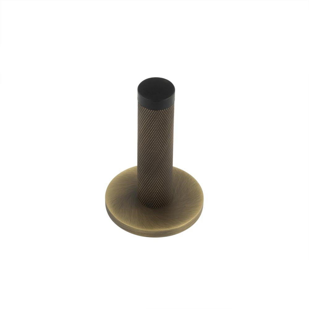 This is an image showing the Frelan - Burlington Knurled Wall Mounted Doorstops Plain Rose Antique Brass available to order from Trade Door Handles in Kendal